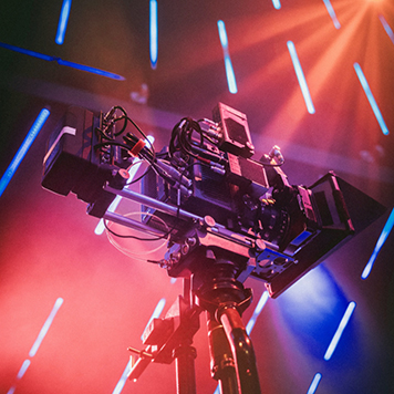 large professional camera surrounded by bright orange lights