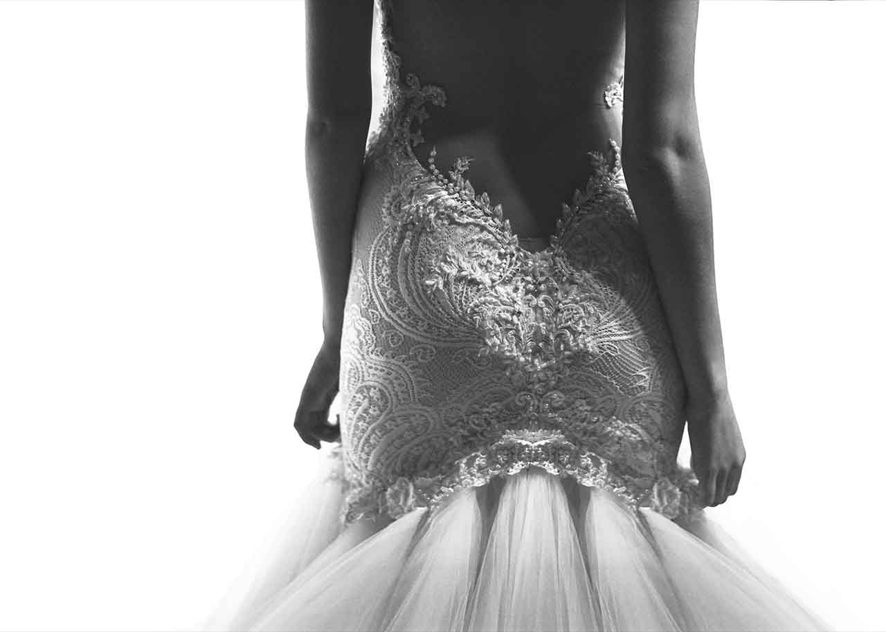 mike colon shot of lower body of female model in backless wedding dress on white background