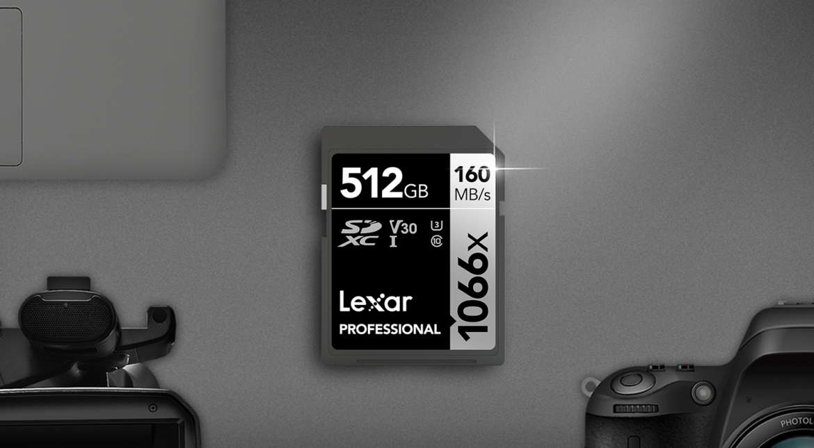 Lexar Professional 1066x SD memory card sitting beside professional camera, microphone, laptop