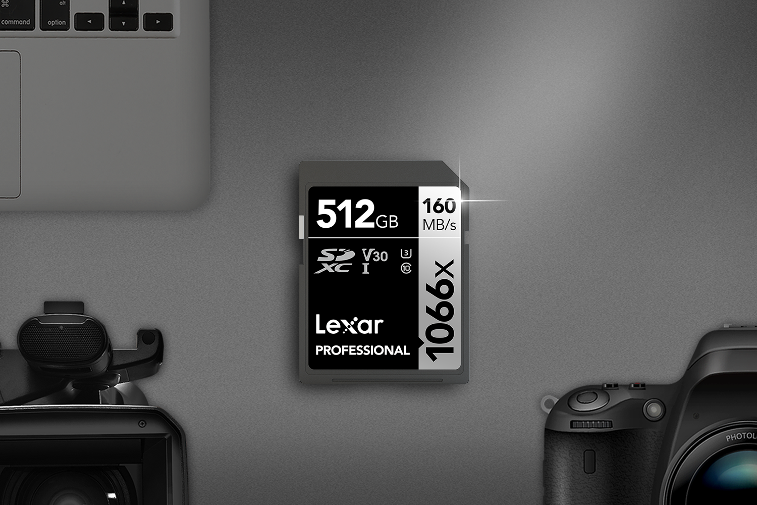 Lexar Professional 1066x SD memory card sitting beside professional camera, microphone, laptop